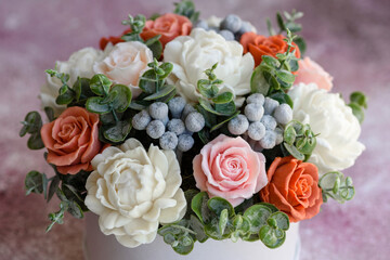 Bouquet of beautiful bright rose flowers in a gift cylindrical cardboard box
