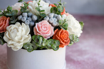 Bouquet of beautiful bright rose flowers in a gift cylindrical cardboard box