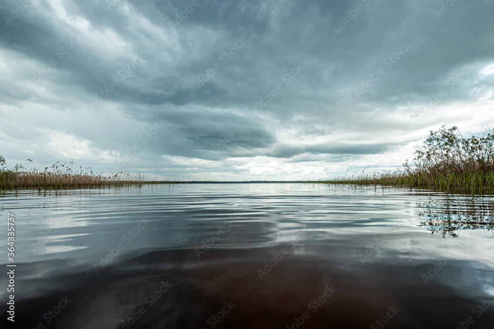 Wall mural Lake and dark clouds, beautiful landscape.