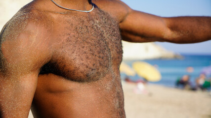 Healthy, fit and muscular black african american man on a beach