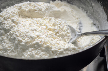Flour in a frying pan, preparation for halva. Armenian recipe