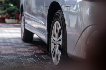 a wheel of a parked car.