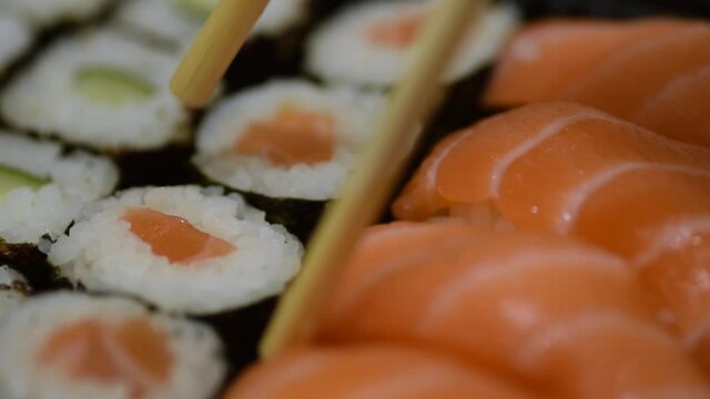 Picking up sushi with chopsticks footage closeup macro