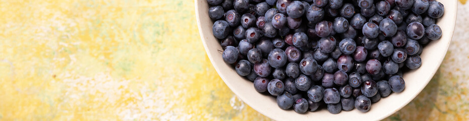 Forest berries blueberry,bramble in a ceramic bowl.Top view.Space for text.Blueberry antioxidant. Concept for healthy eating and nutrition.Border design.Summer healthy food. Banner.
