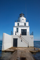 Manitowoc North Breakwater Lighthouse in Manitowoc, Wisconsin in July with girl on steps