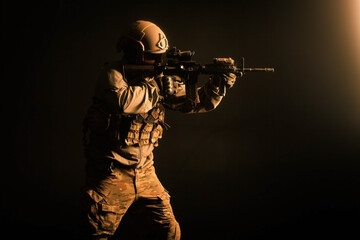 special forces attack, soldier in uniform with a rifle in action, american ranger with guns
