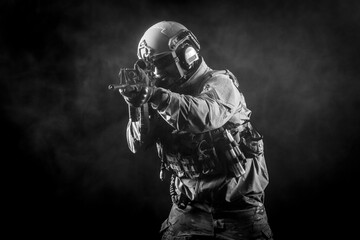 American special forces, a soldier in a military uniform with a weapon attacks on a black background, a ranger for special operations