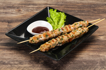 Minced pork skewer kebab with sauce