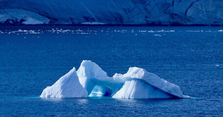 Blue Iceberg in antarctic landscape, with blue waters on a sunny day, Antarctica