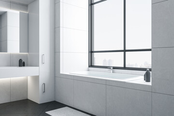 Fototapeta na wymiar White bathroom interior with bath and city view.
