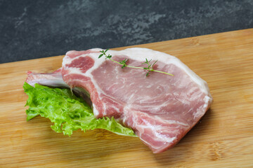 Raw pork bone steak over wooden