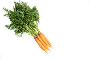 Young carrots with tops on a white background