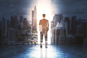 Fototapeta na wymiar Handsome businessman standing on abstract city background.
