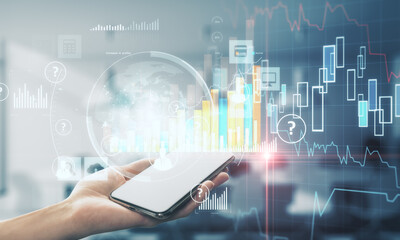 Hand holding cellphone with business report