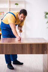 Young male carpenter working indoors