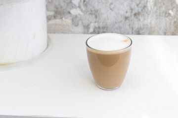 Obraz na płótnie Canvas Glass of coffee with cream on a white background