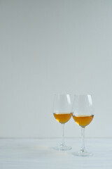 Glasses with white wine staying on the wight background