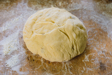 The photo shows a woman forming bread.