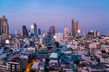 Market behavior graph hologram, sunset panoramic city view of Bangkok, popular location to achieve financial degree in Asia. The concept of financial data analysis. Double exposure.