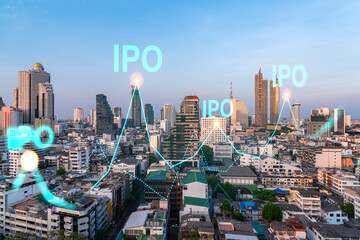 Fototapeta premium Hologram of IPO glowing icon, sunset panoramic city view of Bangkok. The financial hub for transnational companies in Asia. The concept of boosting the growth by IPO process. Double exposure.