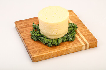 Yellow round dairy soft cheese