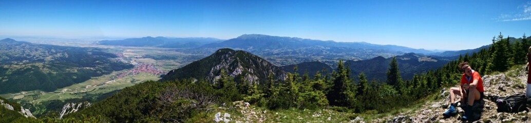 Mountain landscape in the summer with blue sky - panormic view  - hiker resting