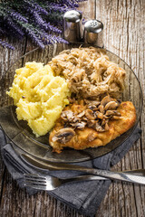 Breaded pork chop with mushrooms.