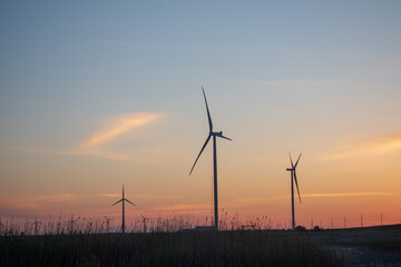 Wind generators turbines. Beautiful landscape at sunset. Green renewable energy