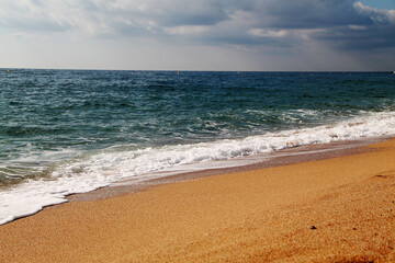 The sea. beautiful beach coast of the sea with waves, horizon and blue sky with clouds. Mediterranean Sea