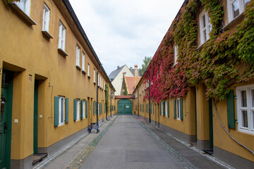 Fototapeta na wymiar The Fuggerei in Augsburg, Bavaria, is the world's oldest social housing complex still in use.
