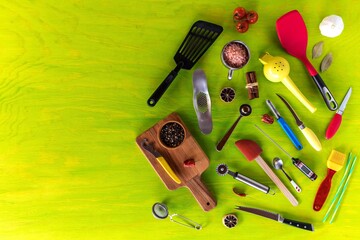 Kitchen utensils on a wooden background. Various kitchen utensils on wooden table. Chef tools. Home cooking.