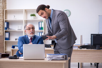 Two male employees working in the office