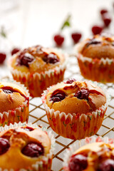 Homemade cherry muffins on a cooling tray close-up view