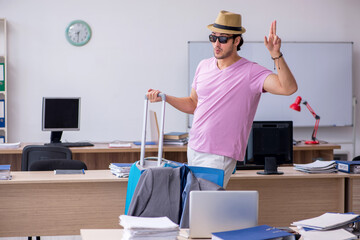 Young male employee preparing for the trip