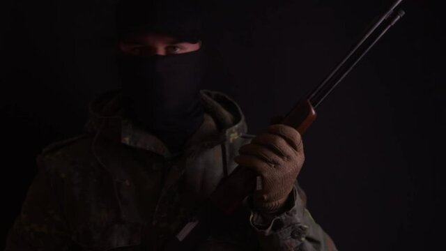 Soldier scanns surroundings with shotgun