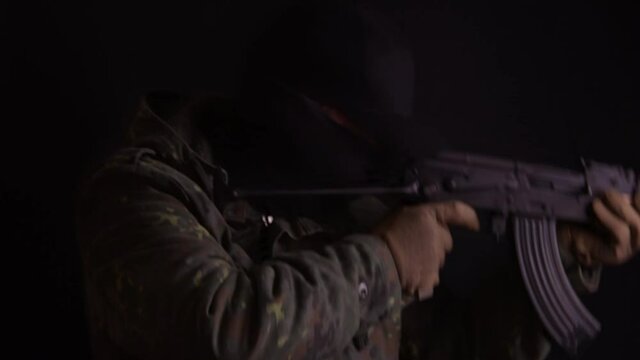 Soldier clears room with his gun, moves away from camera