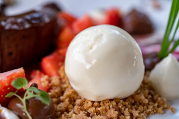 Tasty dessert, hot chocolate cake and vanilla ice cream with fresh strawberry