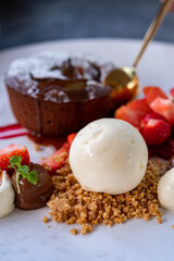 Tasty dessert, hot chocolate cake and vanilla ice cream with fresh strawberry