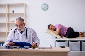 Young male patient visiting old male doctor