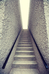 Stairs with railing against two concrete walls