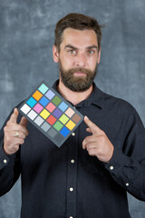 The model holds a color card in its hands for correct color transfer during further color...