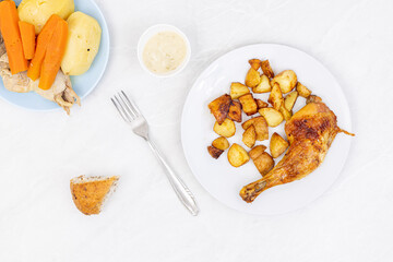 Top view of fried chicken with potatoes and dill sauce