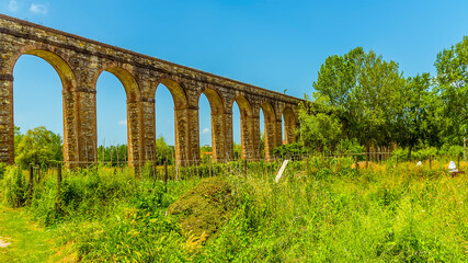 Fototapeta na wymiar A view of the impressive three-kilometer long Nottolini aqueduct in Lucca Italy in summer