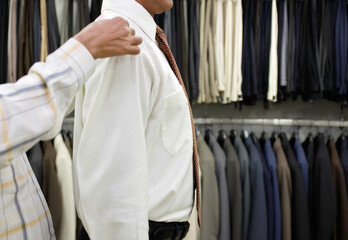 Tailor measuring business man for suit