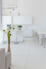 Cozy luxury modern interior design of a studio apartment in extra white colors with fashionable expensive furniture in a minimalist style. white tiled floor, kitchen, relaxation area and workplace