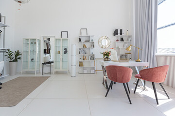 Cozy luxury modern interior design of a studio apartment in extra white colors with fashionable expensive furniture in a minimalist style. white tiled floor, kitchen, relaxation area and workplace