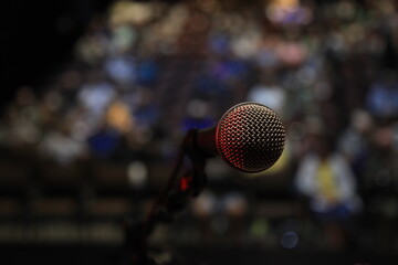 Stepping up to a microphone POV, in front of a crowd