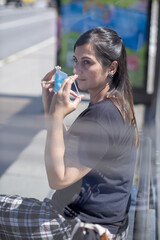 woman putting mask on her face