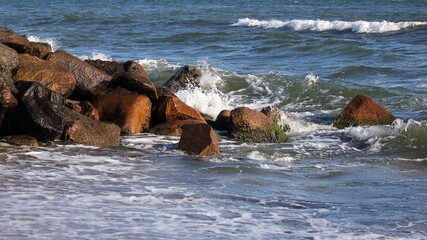 Waves crashing the rocks on the beach