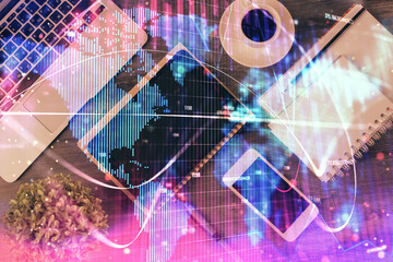 Double exposure of business theme hologram over desktop with phone. Top view. Mobile international trade connection concept.